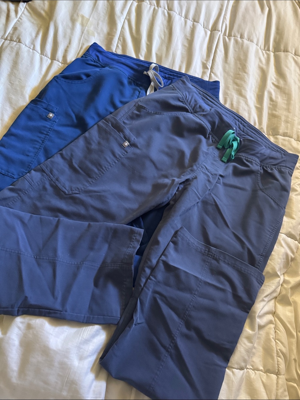 2 pairs of FIG scrub pants. One royal and one navy blue